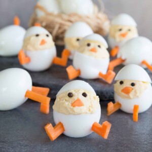 Deviled Egg Chicks with Hard Boiled Eggs in the background in a nest.