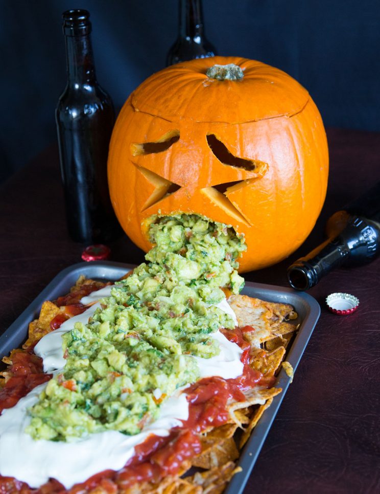 Pumpkin throwing up guacamole over nachos