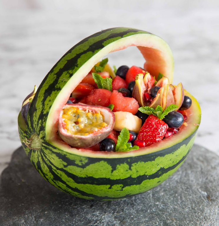 close up shot of watermelon basket on slate with marble background