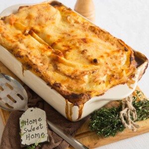 cottage pie fresh out the oven with beef dripping down edges of white casserole dish