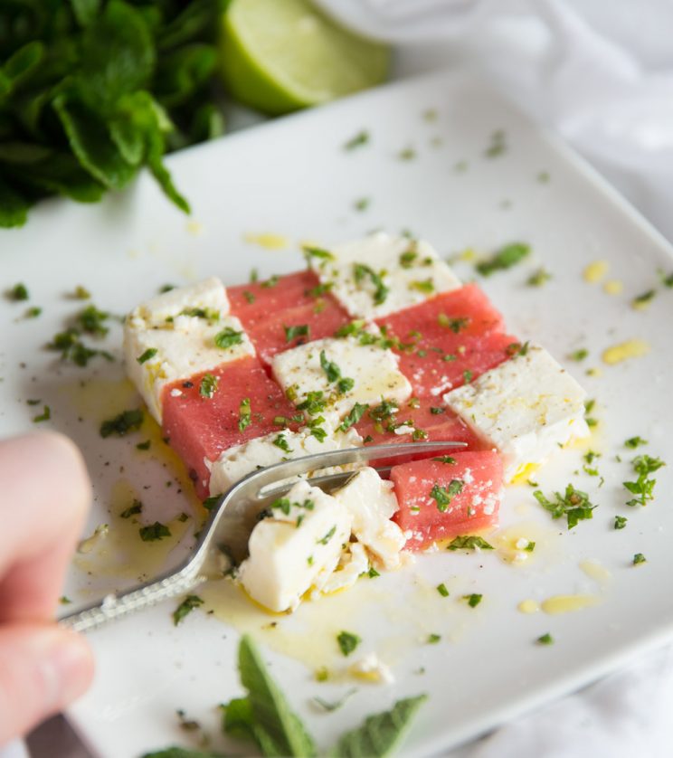 Watermelon and feta salad with mint - slicing with fork