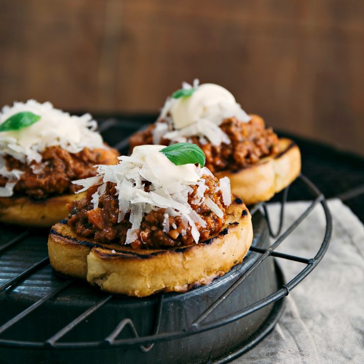 close up shot of bolognese sliders on wire rack tin