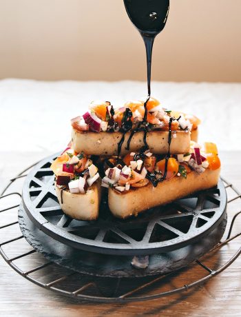 Feta Bruschetta with Balsamic Glaze - pouring over glaze