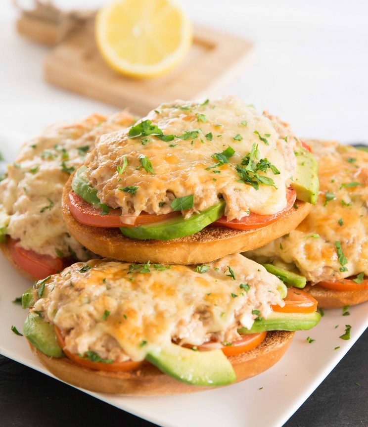 tuna melts stacked on each other with lemon blurred in background