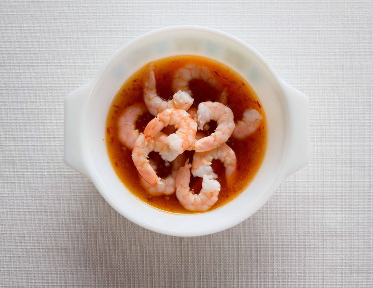 overhead shot of soaking shrimp in sweet chilli sauce