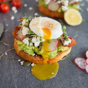 Cafe style smashed avocado on toast Yolk dripping down