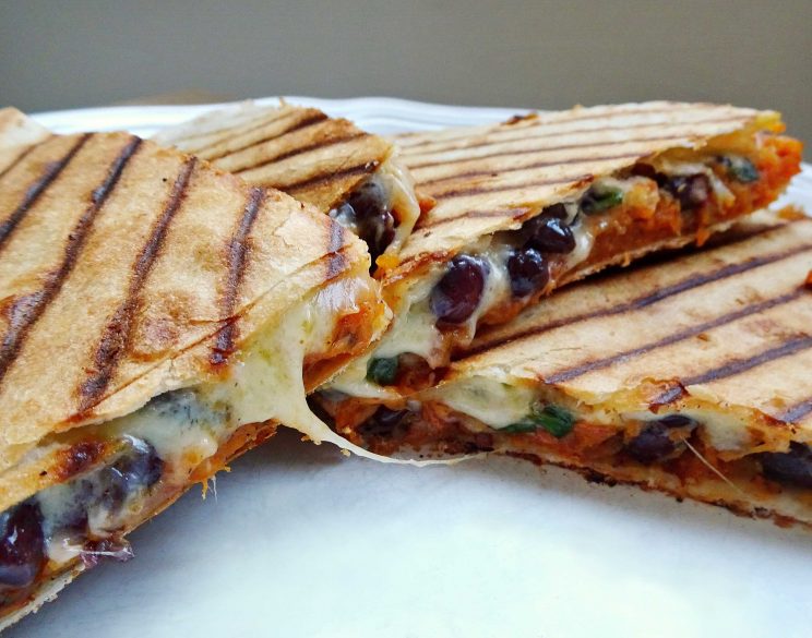 closeup shot of quesadillas cut open showing filling and cheese pull