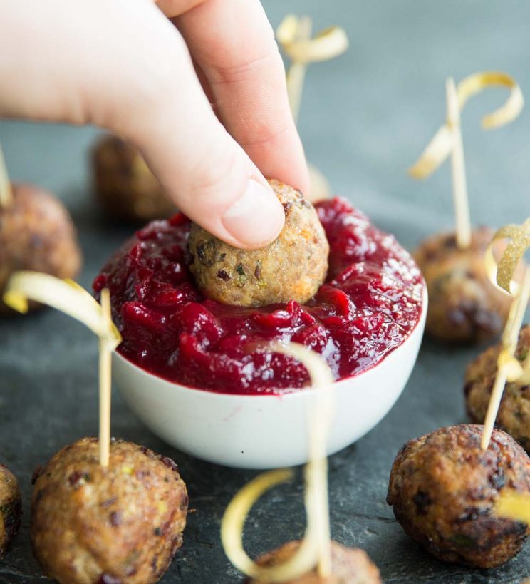 Turkey Meatballs dipping into spiced cranberry sauce