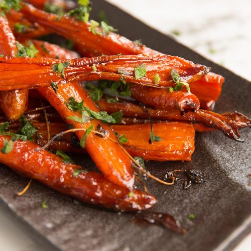 closeup shot of carrots on serving dish garnished with parsley