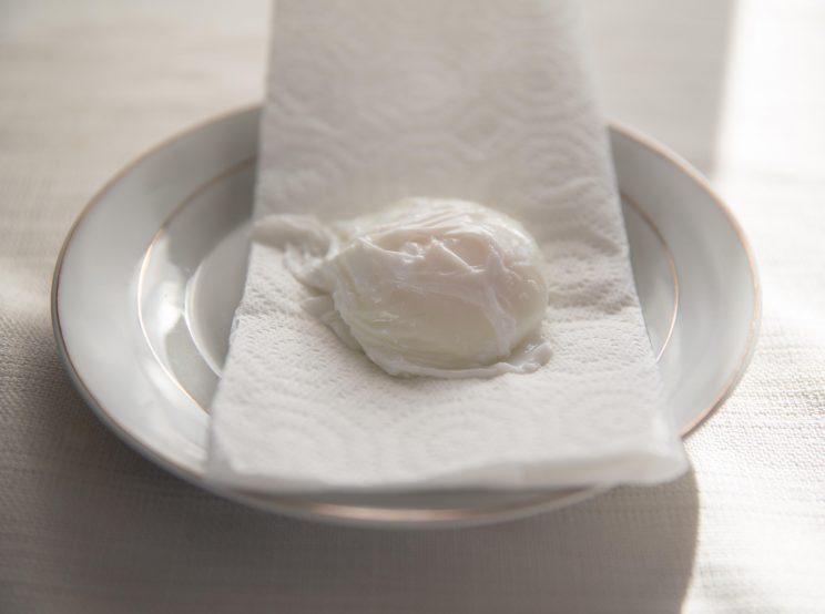 resting poached egg on paper towel