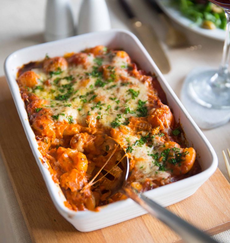 date night gnocchi with serving spoon digging in fresh out the oven