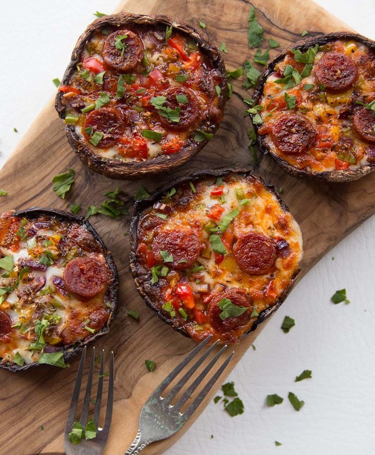 overhead shot of pizza mushrooms served on a chopping board