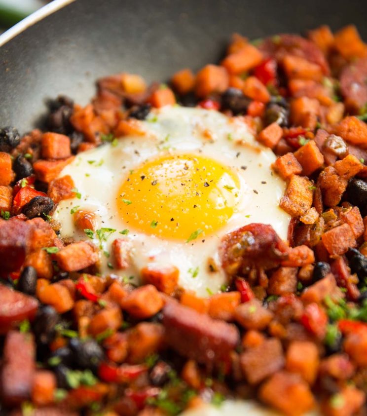 closeup shot of egg in sweet potato hash skillet