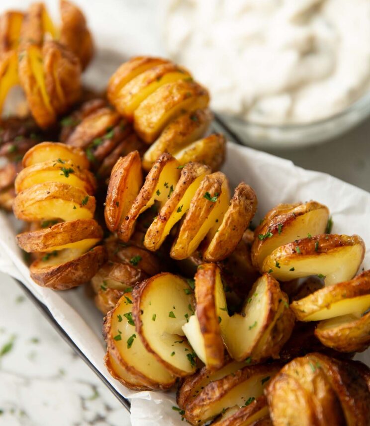close up shot of tornado potatoes in basket garnished with fresh parsley