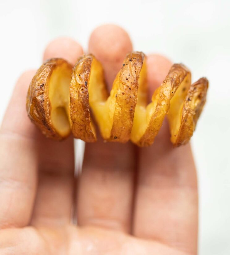 overhead close up shot of hand holding mini tornado potato