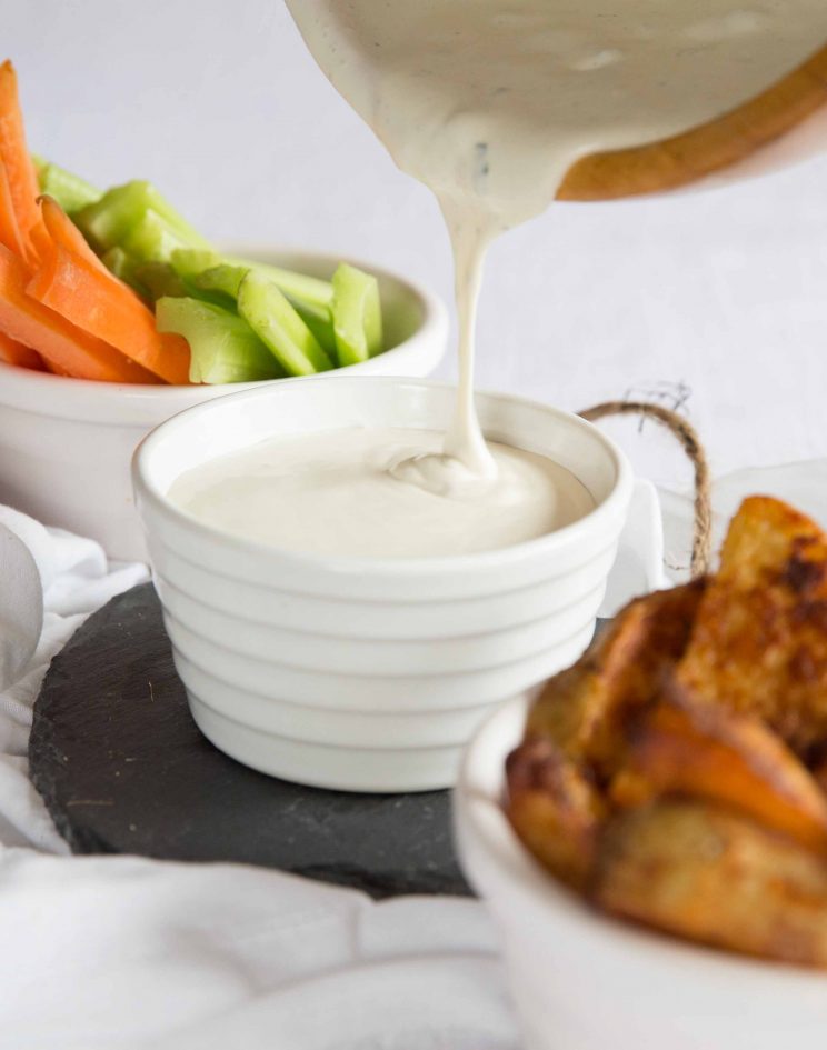 blue cheese dip pouring into dipping bowl