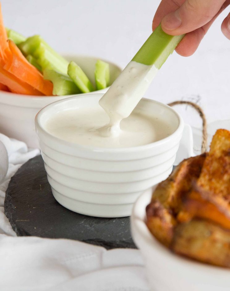 dipping celery into blue cheese dip