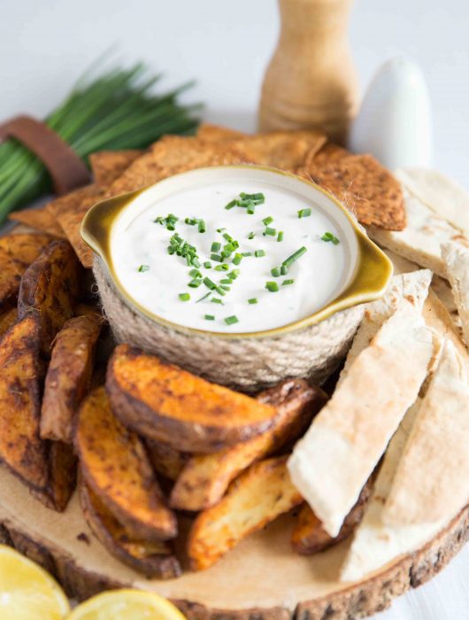 small bowl of dip served with Potato Wedges, Pita Bread and Tortilla Chips