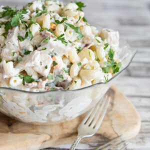 Chicken Bacon Ranch Pasta Salad with fresh parsley in a glass bowl