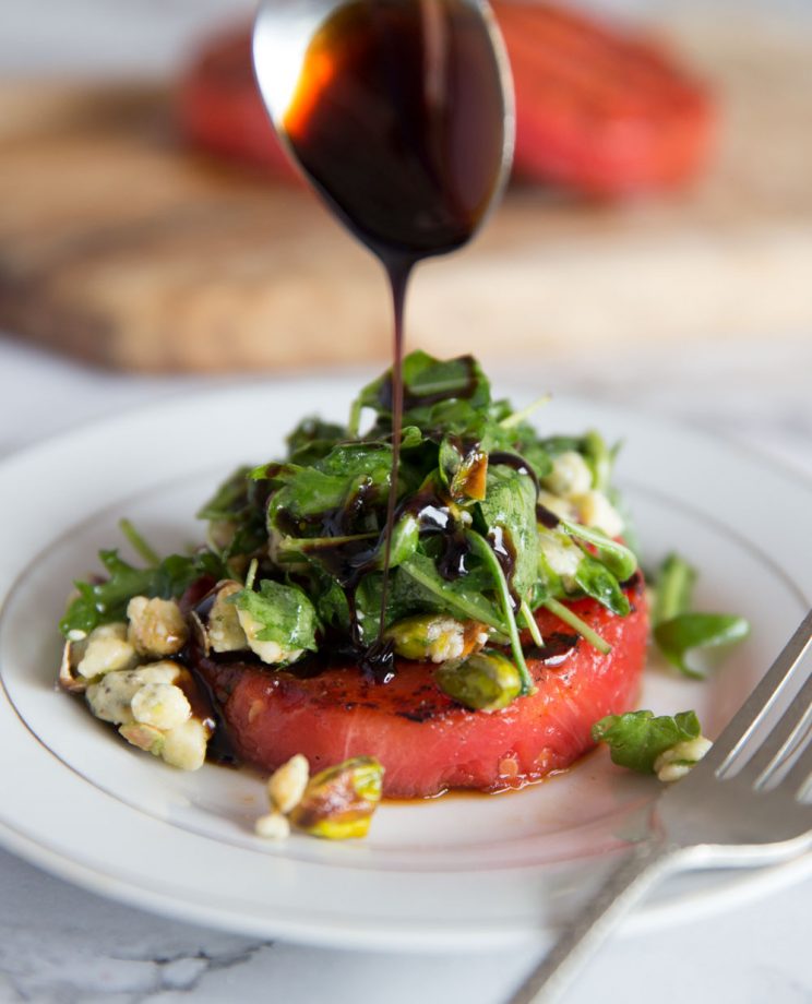 Grilled Watermelon Salad with Balsamic Glaze being poured on top