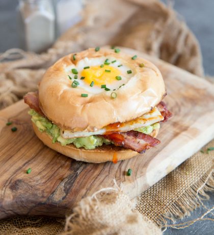 egg in a hole breakfast bagel with chilli jam dripping out