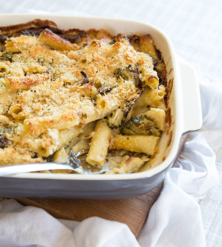 Broccoli Pasta Bake fresh out the oven with serving spoon digging in