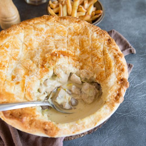 Oven Baked Chicken Leek and Mushroom Pie with serving spoon