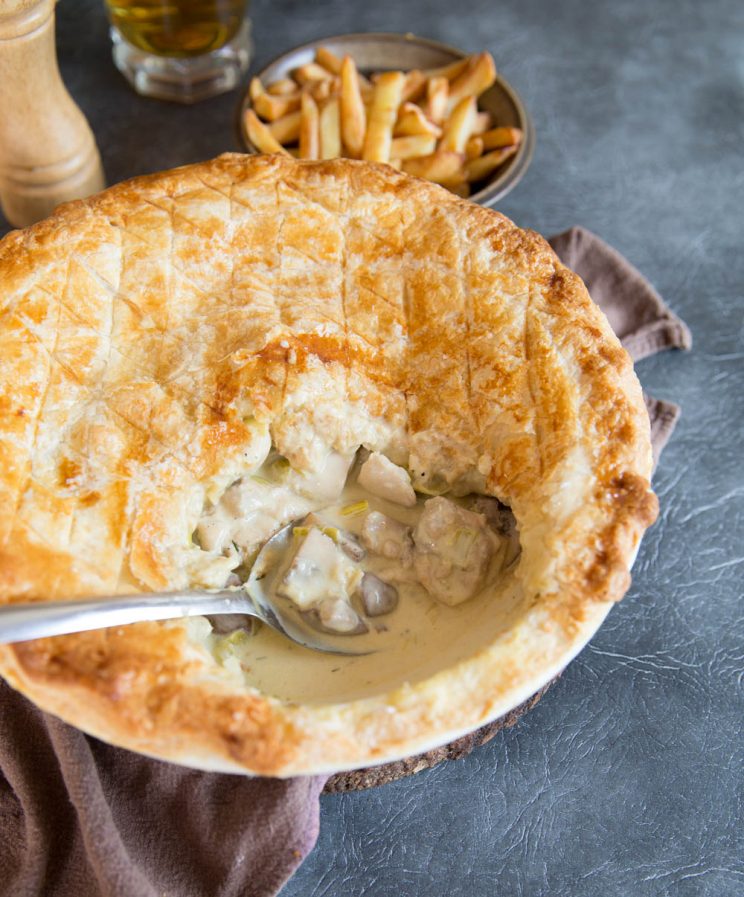 Oven Baked Chicken Leek and Mushroom Pie with serving spoon