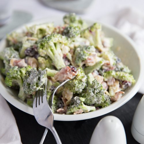 Crunch Broccoli Salad with Bacon served in a bowl with two forks