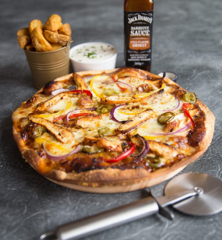 bbq chicken pizza with dip, wedges, bbq sauce and pizza cutter