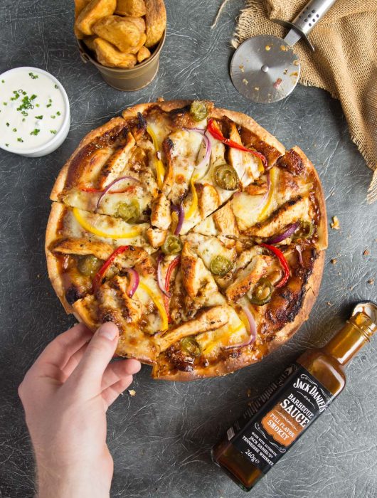 Smokey BBQ Chicken Pizza overhead with wedges and sour cream and chive dip
