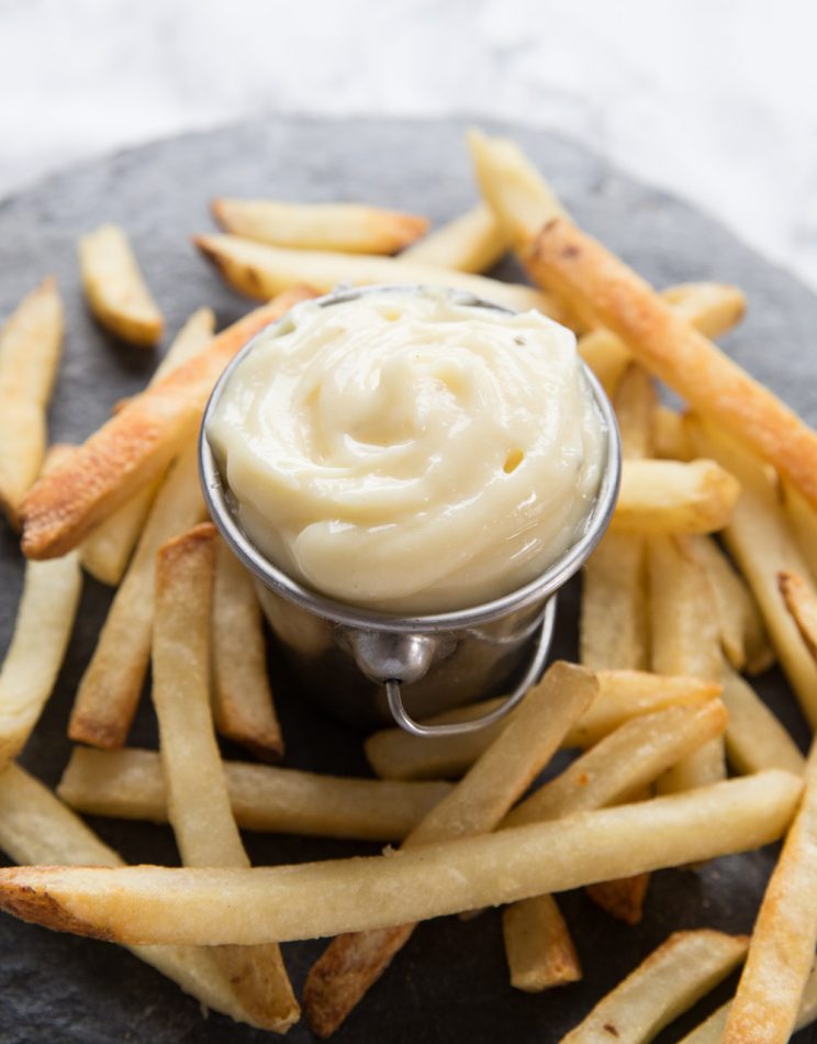 small silver pot of aioli with fries surrounding it