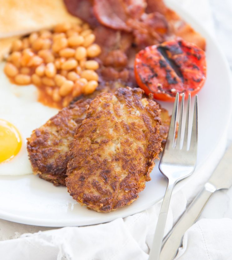 hash browns served with full English breakfast on white plate