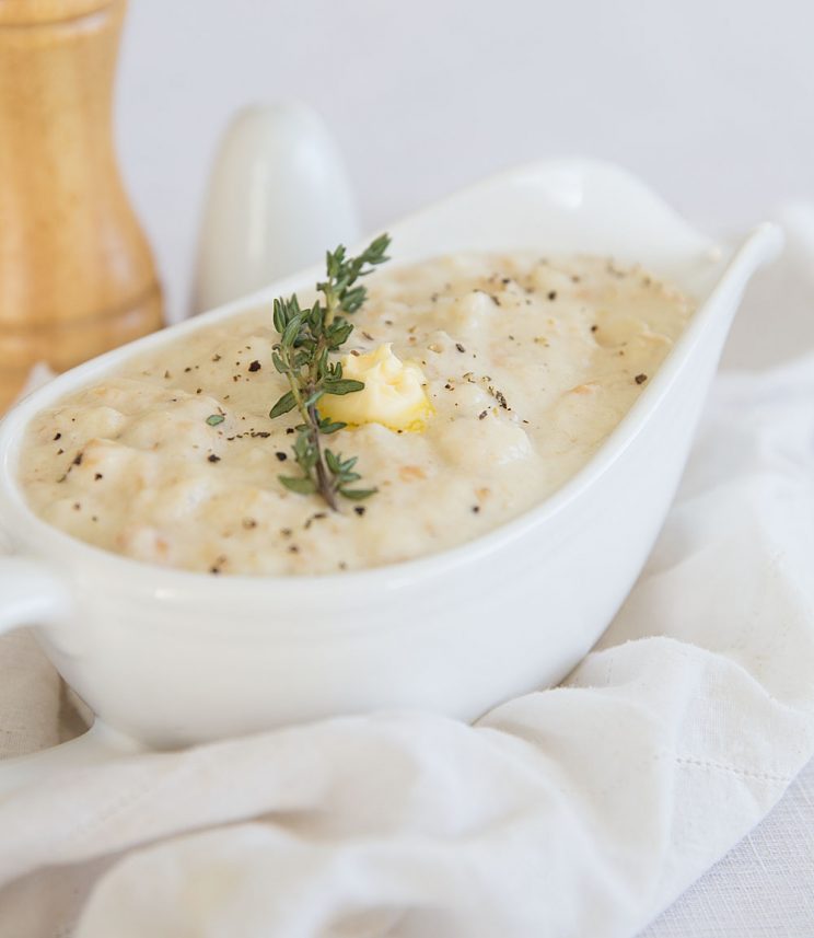 Bread Sauce Recipe in a jug with butter and sat and pepper blurred in background