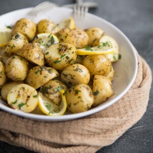 Boiled baby potatoes with lemon and browned butter served with chives and parsley