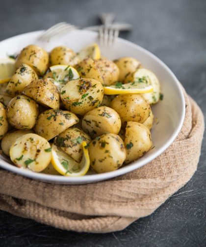 Boiled baby potatoes with lemon and browned butter served with chives and parsley