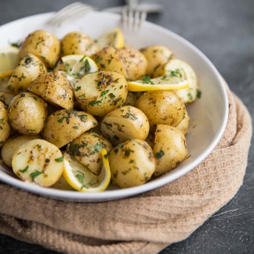 Boiled baby potatoes with lemon and browned butter served with chives and parsley