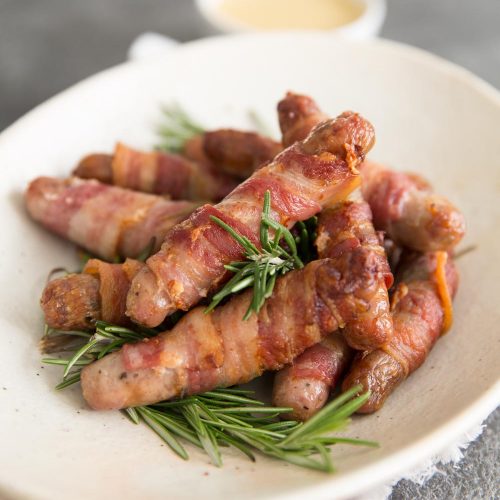 Homemade Pigs in Blankets served with fresh rosemary