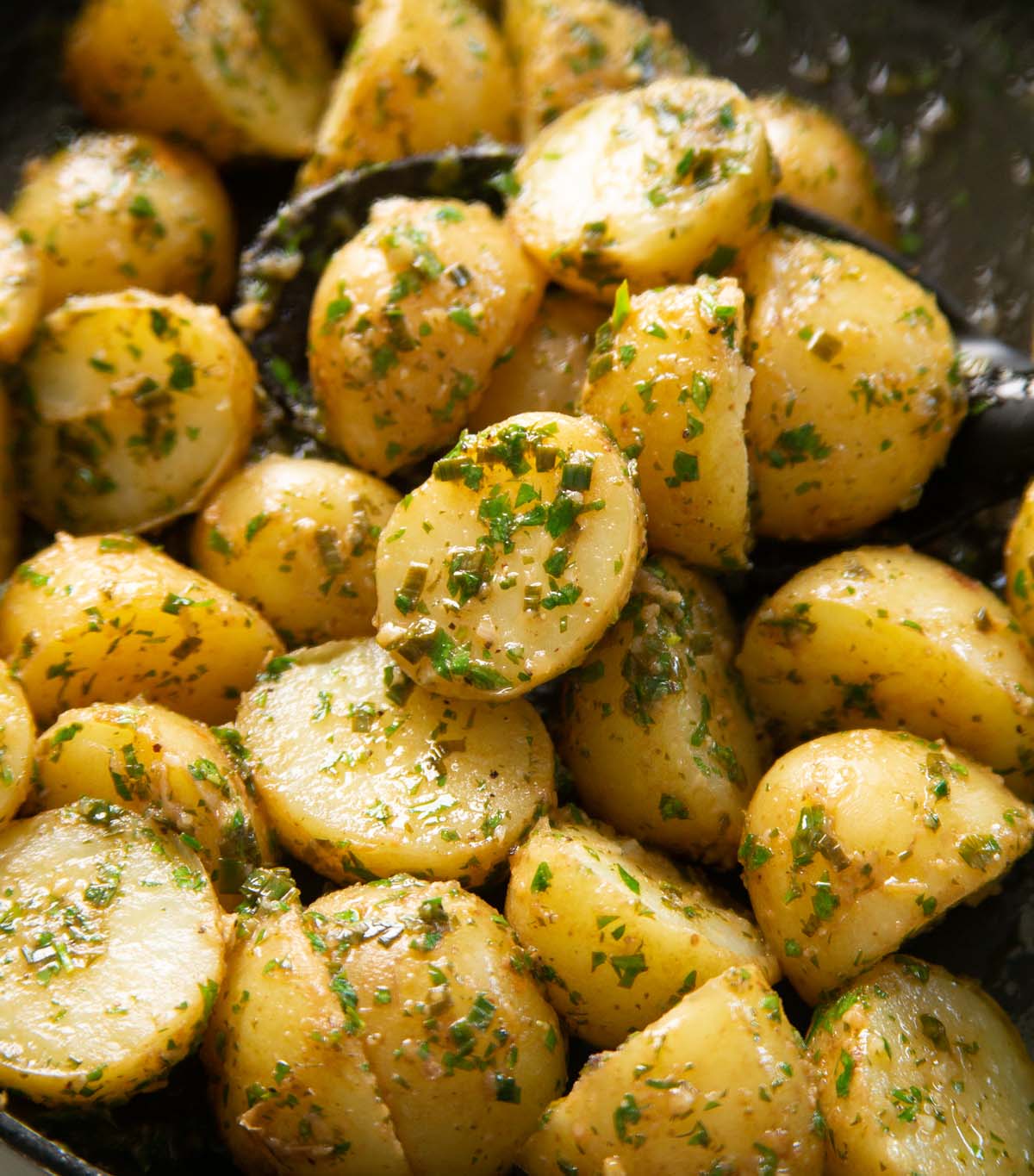 close up shot of lemon butter baby potatoes in pan