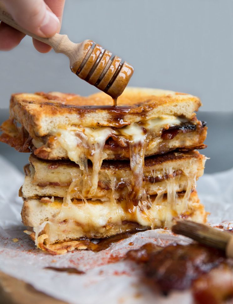 Grilled Cheese with honey dipper pouring over sauce