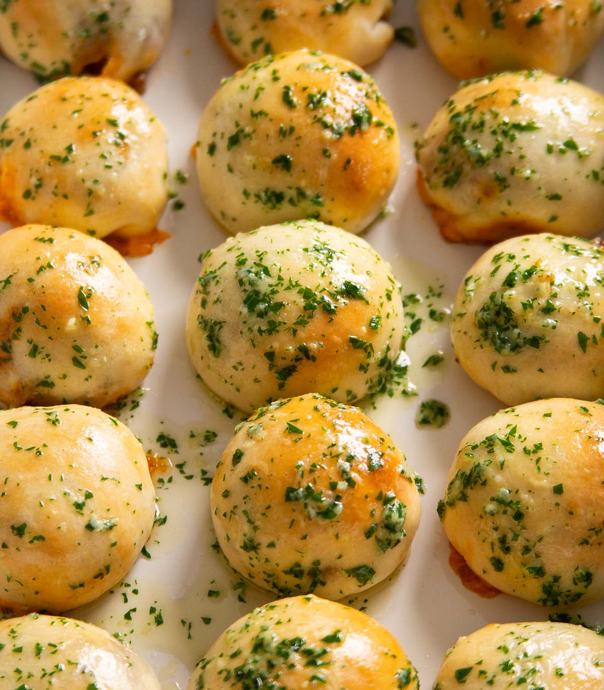 close up shot of leftover chilli dough balls in a row in large baking dish