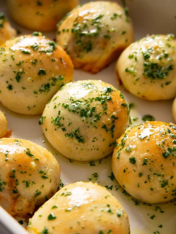close up shot of leftover chilli dough balls fresh out the oven in large white dish