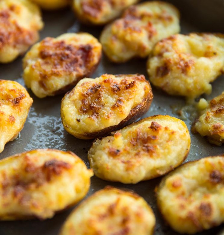 closeup shot of mini potatoes fresh out the oven on baking tray