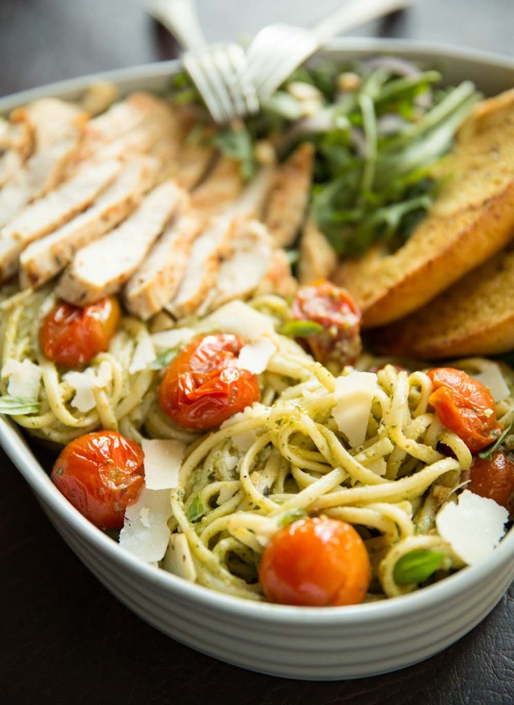 close up shot of pasta in heart shaped bowl with forks resting on top
