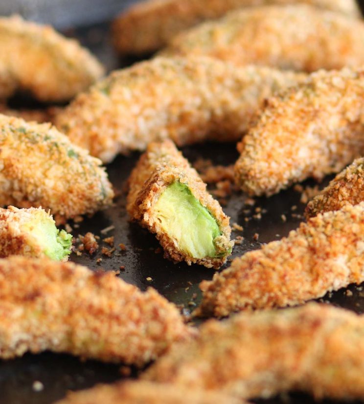 Avocado Fries fresh out the oven with focus on half a fry showing the avocado