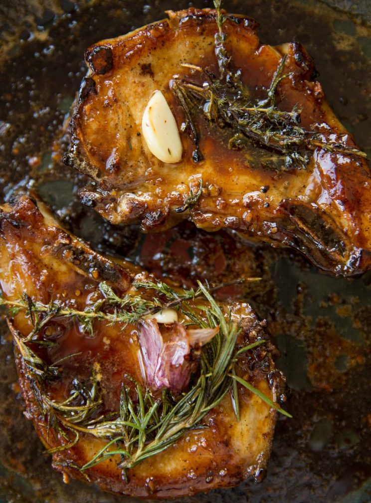 overhead shot of Pork Chops in a frying pan coated in a honey garlic sauce