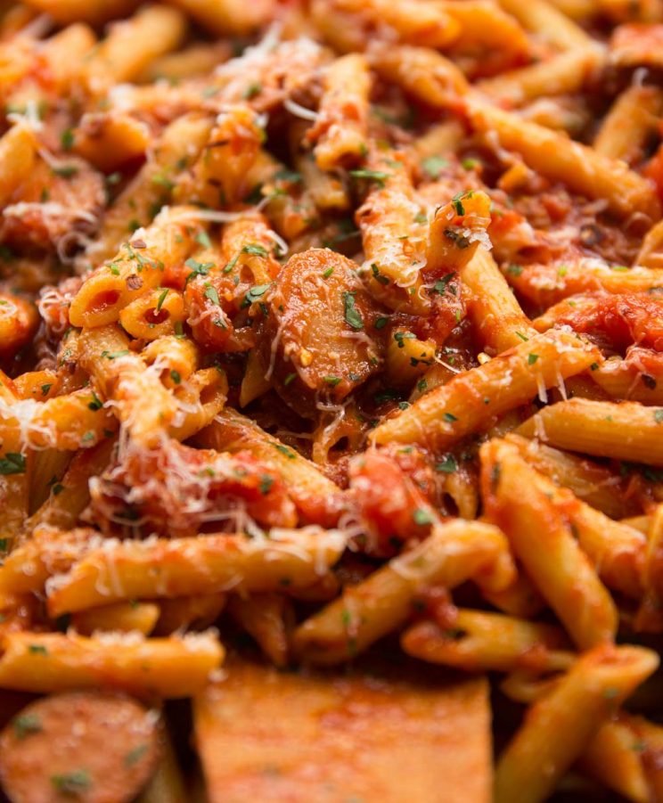 close up shot of Arrabiata in a saucepan wit extra chilli flakes on top