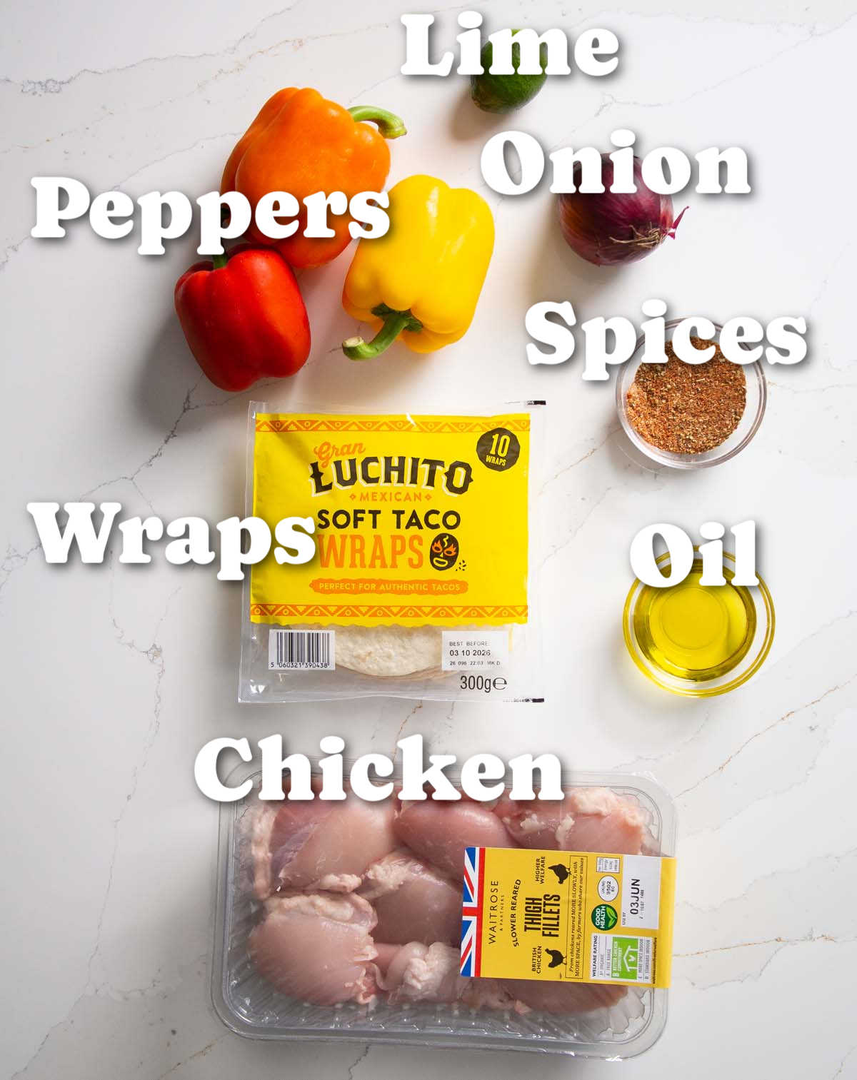 overhead shot of sheet pan chicken fajitas ingredients with text labels