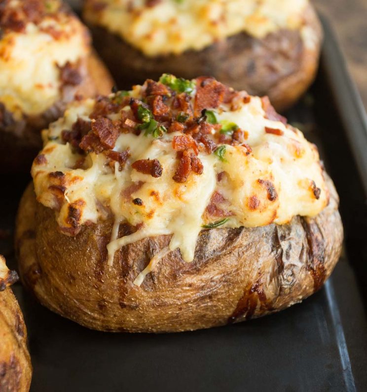 Twice Baked Potatoes fresh out the oven. Focus on one, 3 blurred in the background