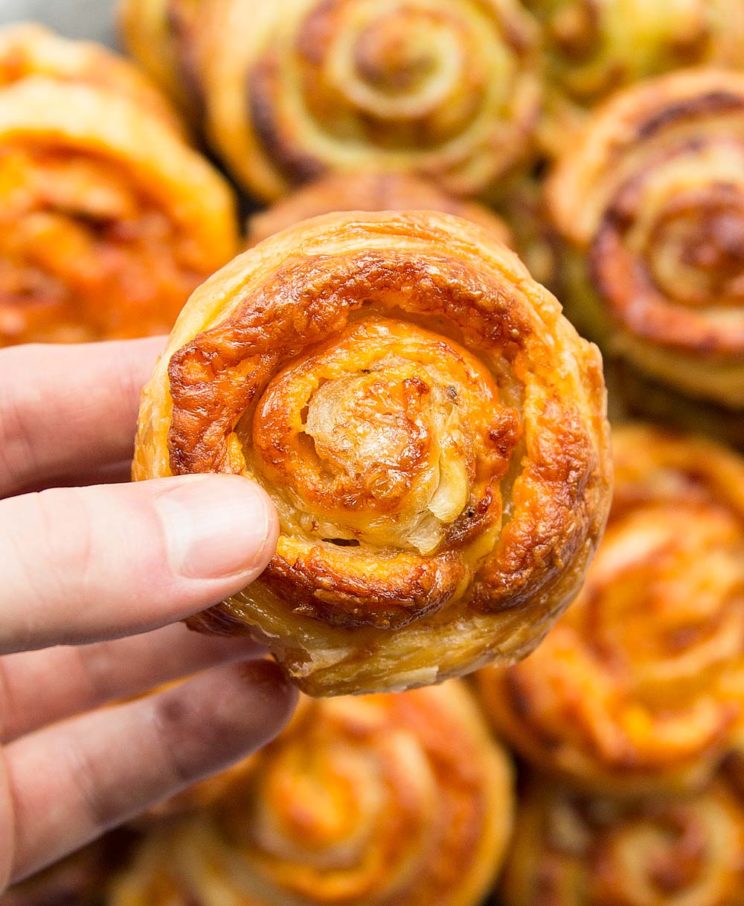 overhead shot of Cheese and Prosciutto Puff Pastry Pinwheels with other pinwheels blurred in the background